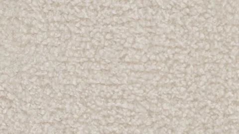 Slow moving close-up shot of fluffy white wool fabric displaying soft texture Stock Footage 303145583