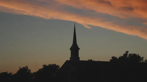 Slow moving cloud as evening descends behind church steeple, 4K. Stock Footage 243904467