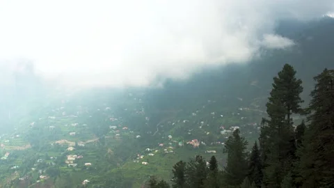 Slow moving clouds beautiful greenery small houses over mountain and trees Stock Footage 158537068