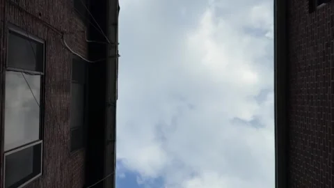 Slow Moving Clouds Between Weathered Brick Buildings, Low Angle Urban Sky Stock Footage 342343774