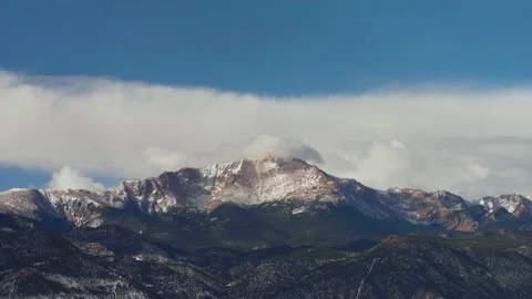 Slow moving clouds over snow covered mountain Pike's Peak 14,110 feet Stock Footage 229439019
