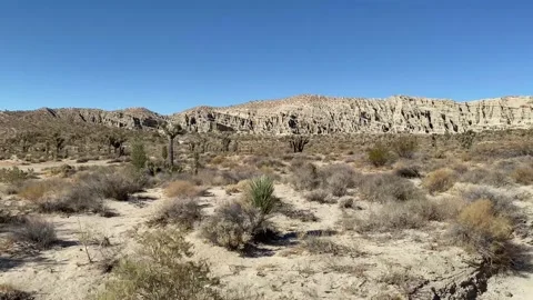 Slow moving desert arid mountain ridge cliff driving motion empty deserted Stock Footage 213785156
