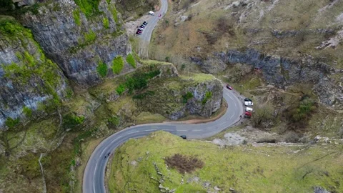 Slow moving drone over cheddar gorge with upwards pan at the end showing cheddar Stock Footage 235226859