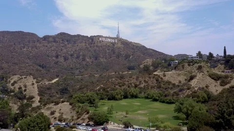 Slow moving drone pulls away from the iconic Hollywood sign on Mount Lee Stock Footage 124941762