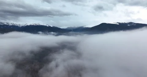 Slow moving drone shoot in thick fog in the morning. Mountains in the background Stock Footage 174422927