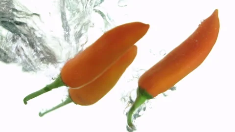 Slow-moving heaps of fresh red peppers fell into the water. Stock Footage 241324292