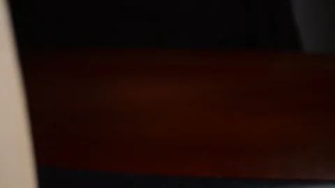 Slow moving macro shot down the inside of a book as it slowly closes RED 8K Stock Footage 122604785