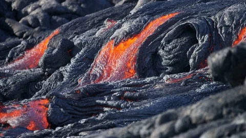 Slow moving river molten hot lava making a barren wilderness of the land it Stock Footage 74670540