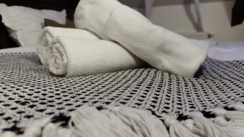 Slow-moving shot captures nice arranged stack of neatly rolled towels in old Stock Footage 306287197