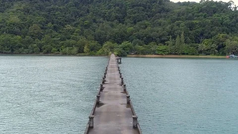Slow moving shot over a concrete pier after rainfall on an island Cropped Video stock 99214918