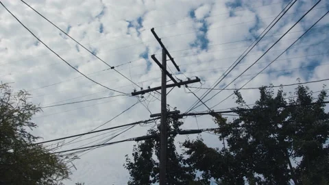 Slow Moving Timelapse of Clouds behind a Residential Power Line and Phone Line Stock Footage 137925945