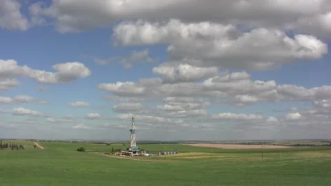 Slow moving Timelapse clouds cumulus above drilling rig wide Stock Footage 268260013