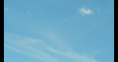 Slow moving timelapse white clouds. Blue sky with   layers of clouds. Stock Footage 305526990