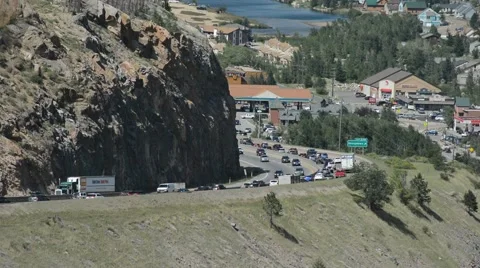 Slow Moving Traffic Jam Around a Curve in the Mountains with a Reservoir Stock Footage 66436205