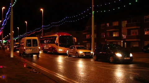 Slow moving traffic at night with colored street lights Stock Footage 48484109