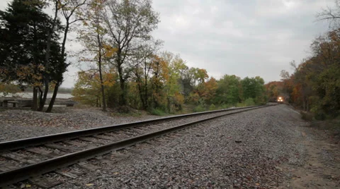 Slow moving train through fall forest. 1080 Stock Footage 29509858