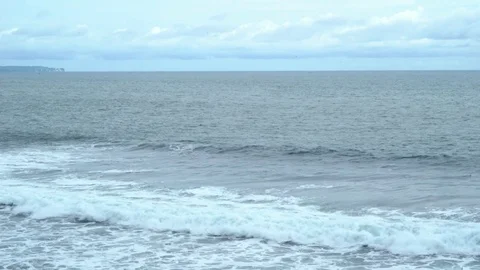 Slow moving waves on a couldy, blue day in Bali Video stock 74302331