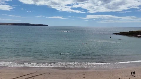 Slow Moving Waves Roll onto Beach on Clear Blue Day Drone Footage Stock Footage 342294158