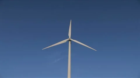 Slow moving windmill against blue sky wide Video stock 5700982