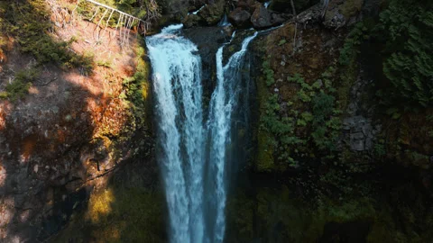 Slow orbit around Falls Creek Falls waterfall plunging cold water into deep 動画素材 337620756