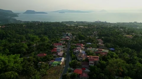 Slow orbit drone shot of dramatic sunset clouds and lush greenery overlooking Stock Footage 336480846