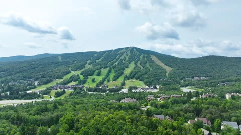 Slow orbit of green ski mountain in summer 4k 60FPS 動画素材 302026248