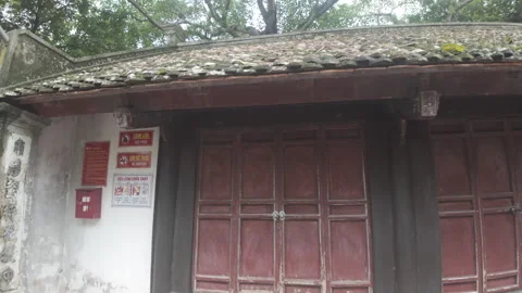 Slow orbit shot of a wall and doors at an ancient temple Stock Footage 289800160