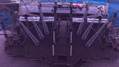 Slow overhead drone flyover above concert stage inside Etihad Stadium Stock Footage 341902946