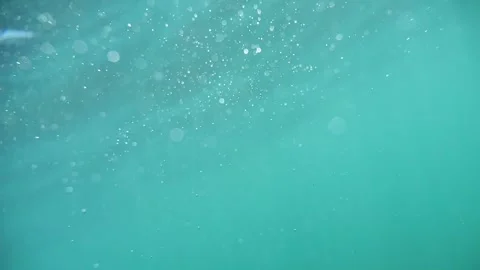 Slow-paced underwater visual of effervescent bubbles in blue, with dancing .. Stock Footage 252128565