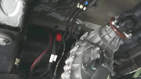 Slow pan to 4x4 wheel drive transfer case in a Mercedes Sprinter van Stock Footage 245722612