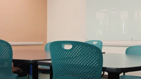 Slow pan across empty meeting room with chairs and whiteboard Stock Footage 332636142