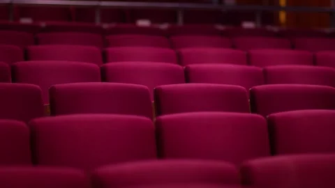 Slow Pan Across Rows of Empty Red Upholstered Theatre Seats Stock Footage 257971469