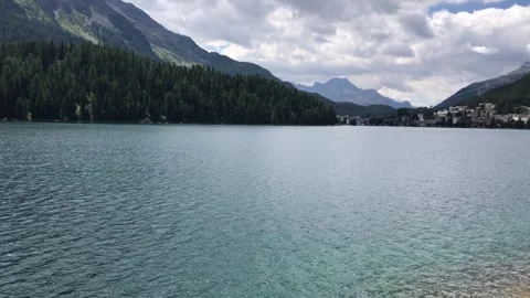 Slow pan across St. Moritz lake with St. Moritz, Switzerland in the background Stock Footage 256250530