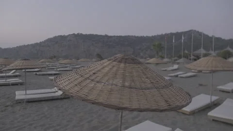 An slow pan across sunbeds at the turtle nesting beach Istuzu Stock Footage 232304178
