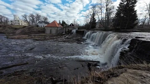 Slow pan across a waterfall and historic mill in a river landscape Stock Footage 337554438