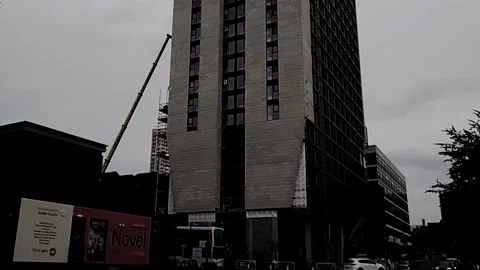 Slow pan up on building that is under construction Video stock 160220478