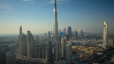 Slow pan up Burj Khalifa while tracking right over Business Bay at 150m. Stock Footage 98944697
