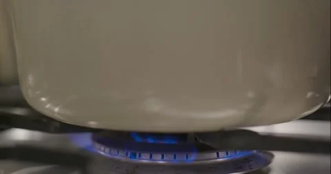 Slow Pan Down of Pot on Gas Stove Stock Footage 261902251