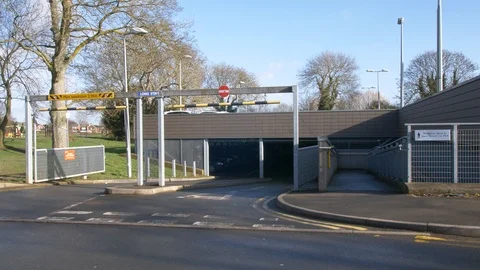 Slow pan at the enterance to an active car park Stock Footage 94591494