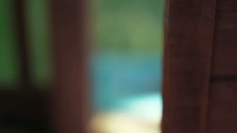Slow pan up extreme close up of red weathered wood window sill lintel to chil Stock Footage 95032824