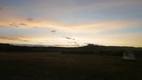 Slow pan of grassy flat on prairie before sunrise Stock Footage 75219984