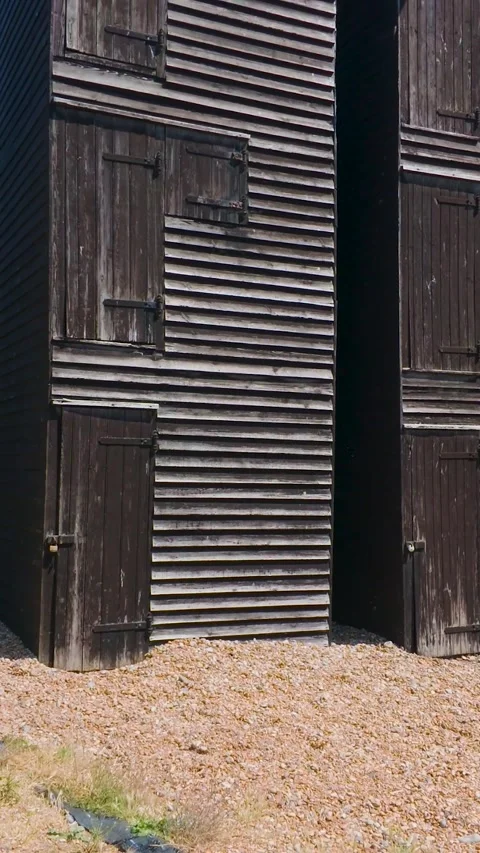 Slow Pan Up of Historic Net Shops in Hastings Old Town, England. Vertical Stock Footage 342236047