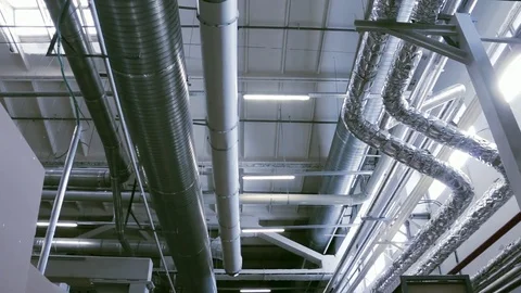 Slow pan of industrial conditioning, heating and ventilation pipes Stock Footage 75708066