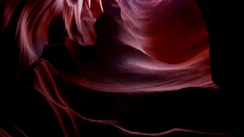 Slow pan inside dark red rock slot canyon walls Stock Footage 329559615