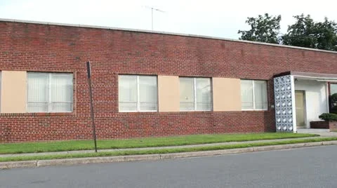 Slow Pan Left Exterior of Small Warehouse Stock Video Stock Footage