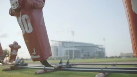 Slow pan left to right of tackling dummies on football field Stock Footage 104768131