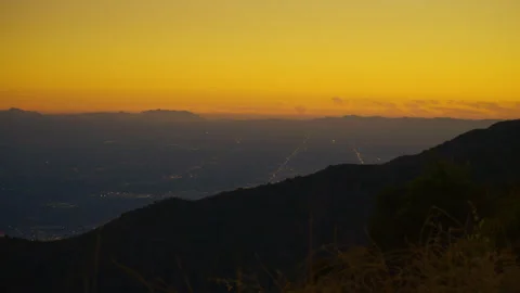A slow pan left of the valley landscape during sunset in valley in California Stock Footage 282051937
