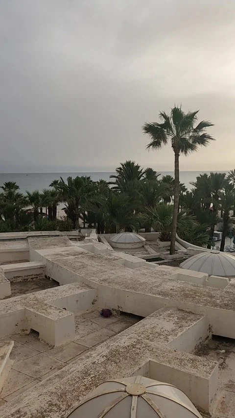Slow Pan of Luxury Hotel Grounds at Dawn with Sunrise and Sea View Stock Footage 340169368