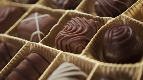 Slow pan over the assorted chocolate box 4K video Stock Footage 144073608