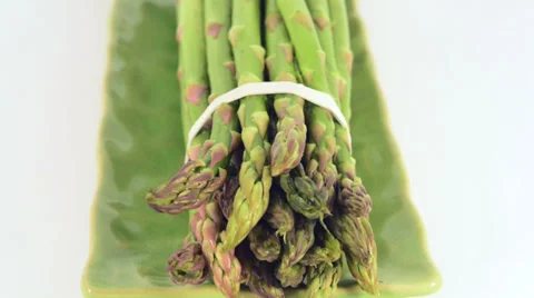 Slow pan over a bunch os asparagus on a plate Stock Footage 36157173